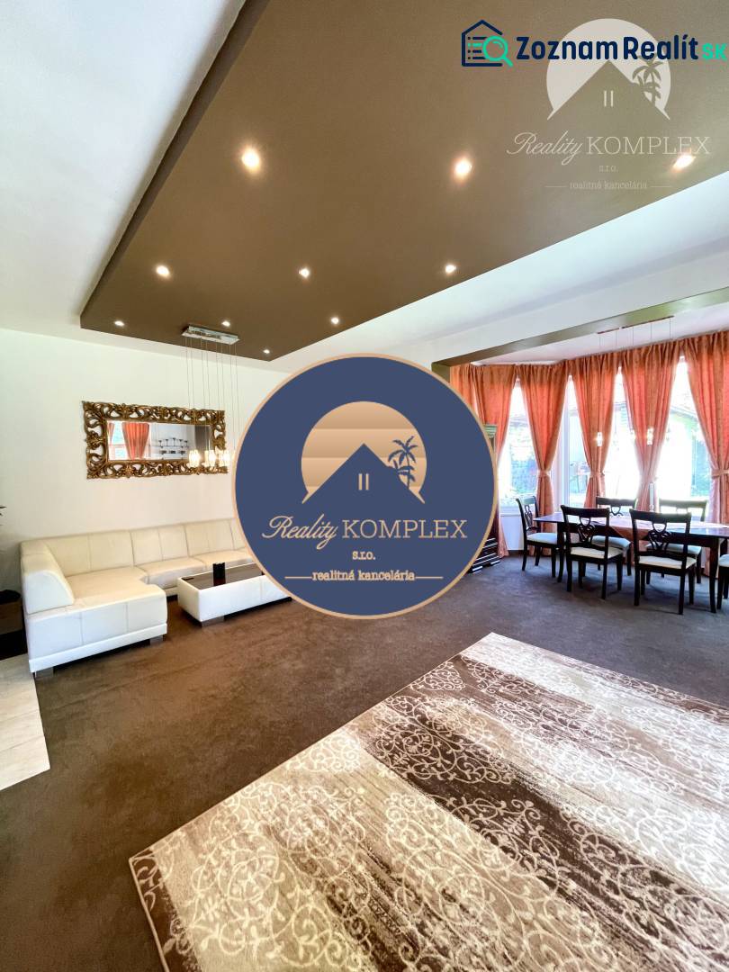 Living room with carpet decor, sofa, and dining table in a family house.