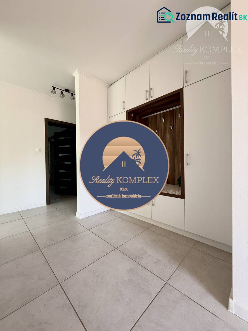 Interior of a family house with light tiles and built-in wardrobes.