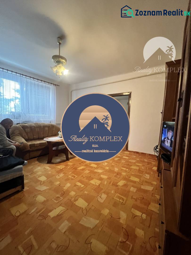 Living room in a family house with a sofa and wooden decor flooring.