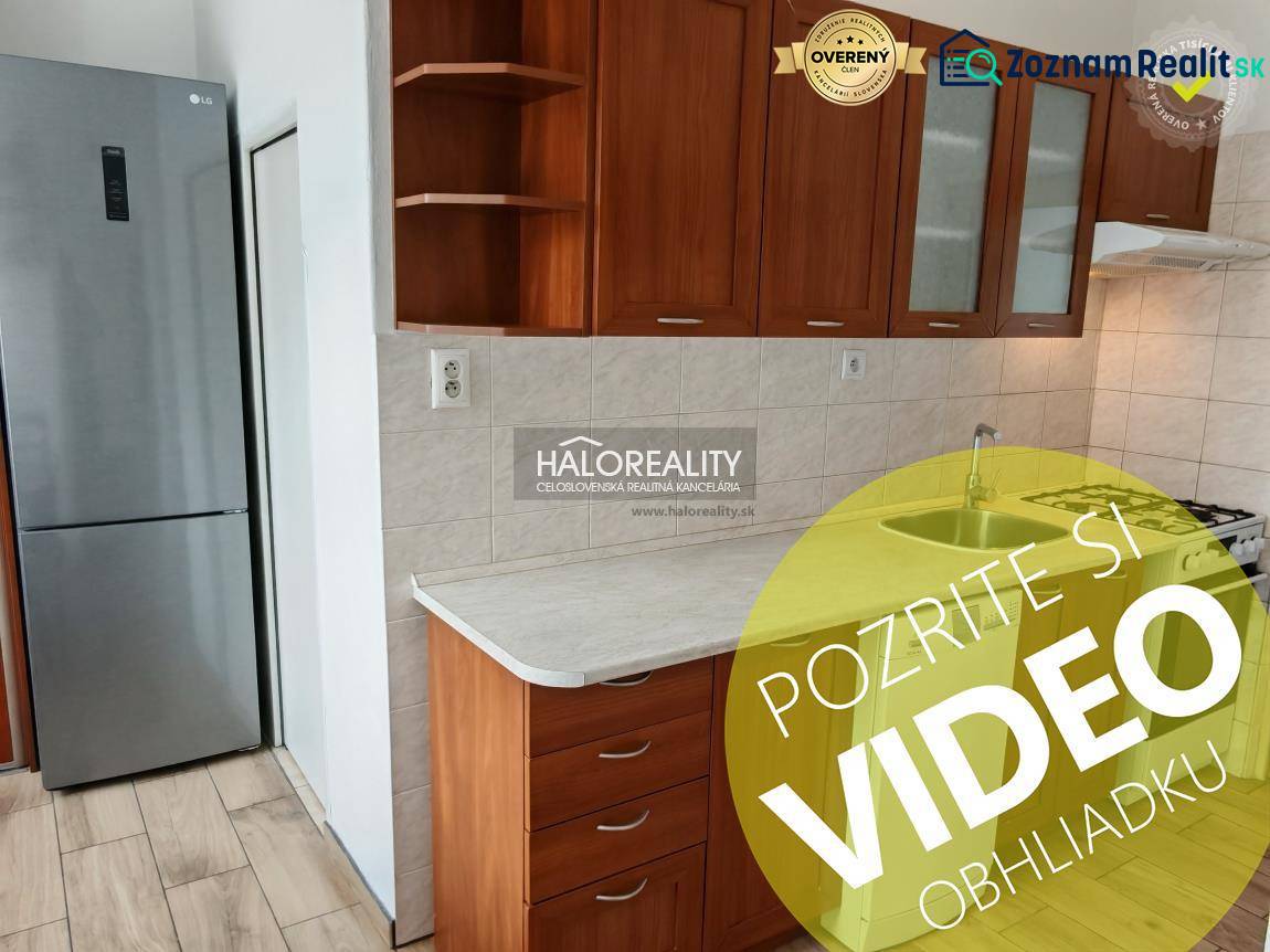 A kitchen in a 3-room apartment with a wooden decor floor and built-in cabinets.