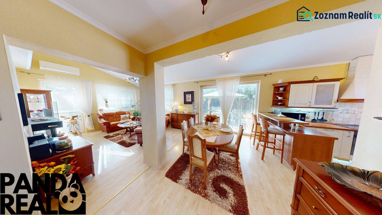 Dining room with kitchen and living room in a family house, floor with wooden decor.