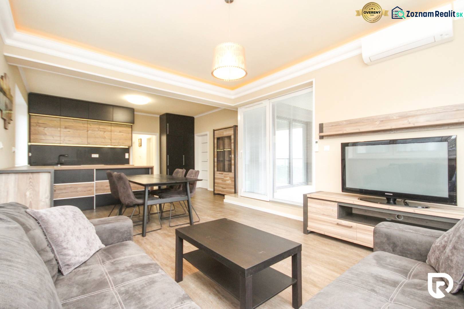 Living room with kitchen in a 3-room apartment, wooden decor flooring, comfortable furniture.