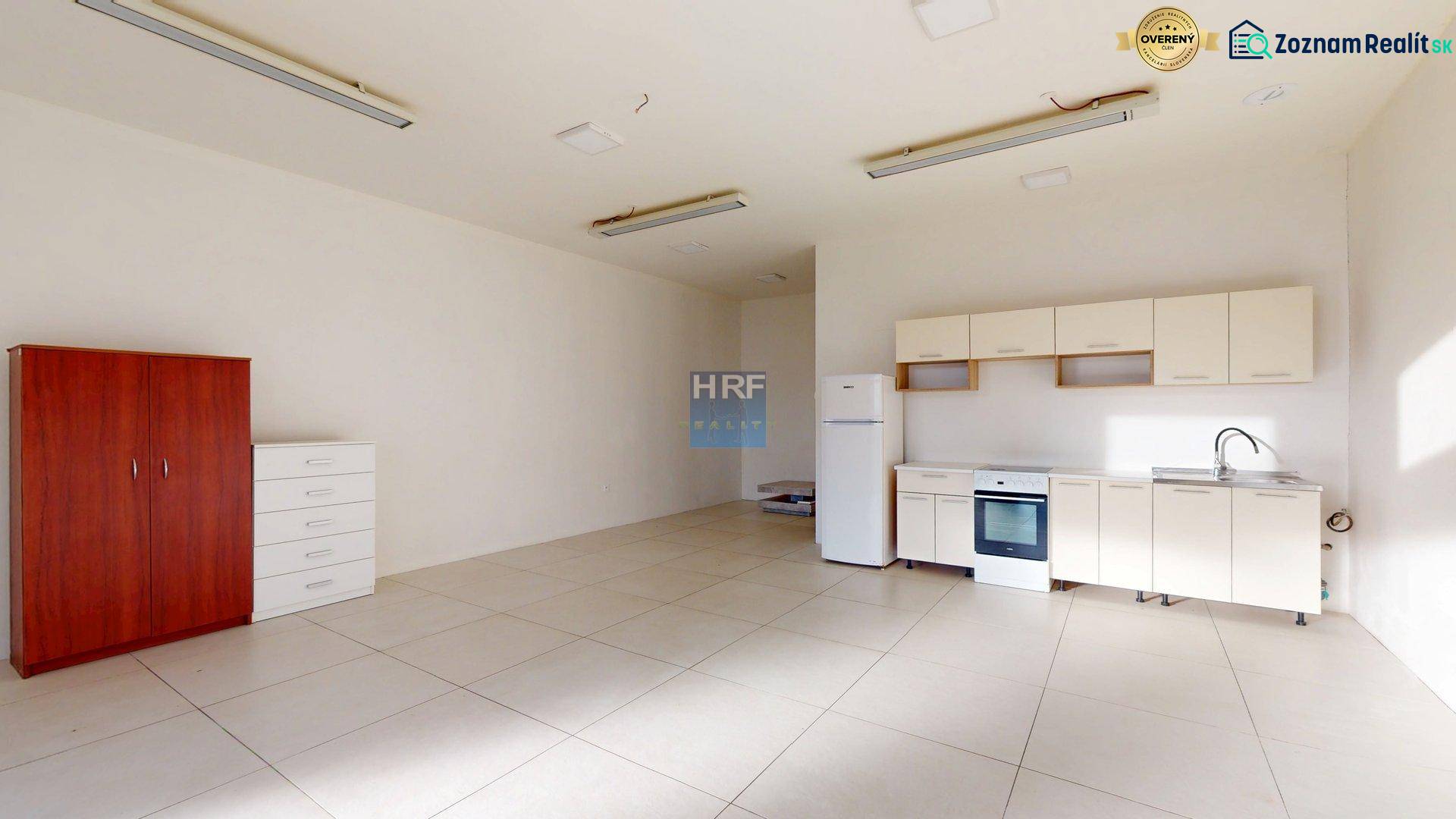 Commercial premises with a kitchenette and storage space on a floor with a wooden decor.