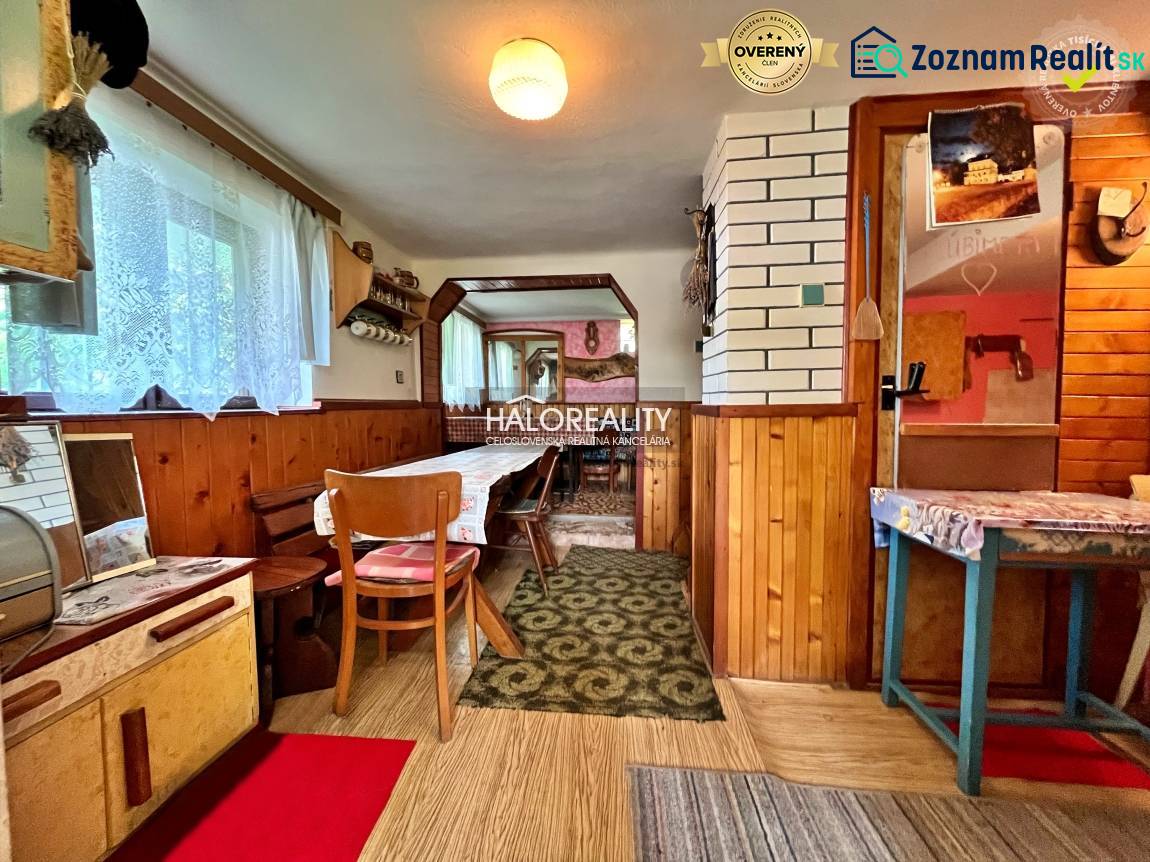 Interior of a cabin with wooden decor and a dining table.