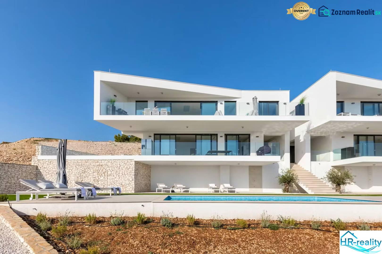 A holiday apartment in Rogoznica with a garden, terrace, and sun loungers by the pool.