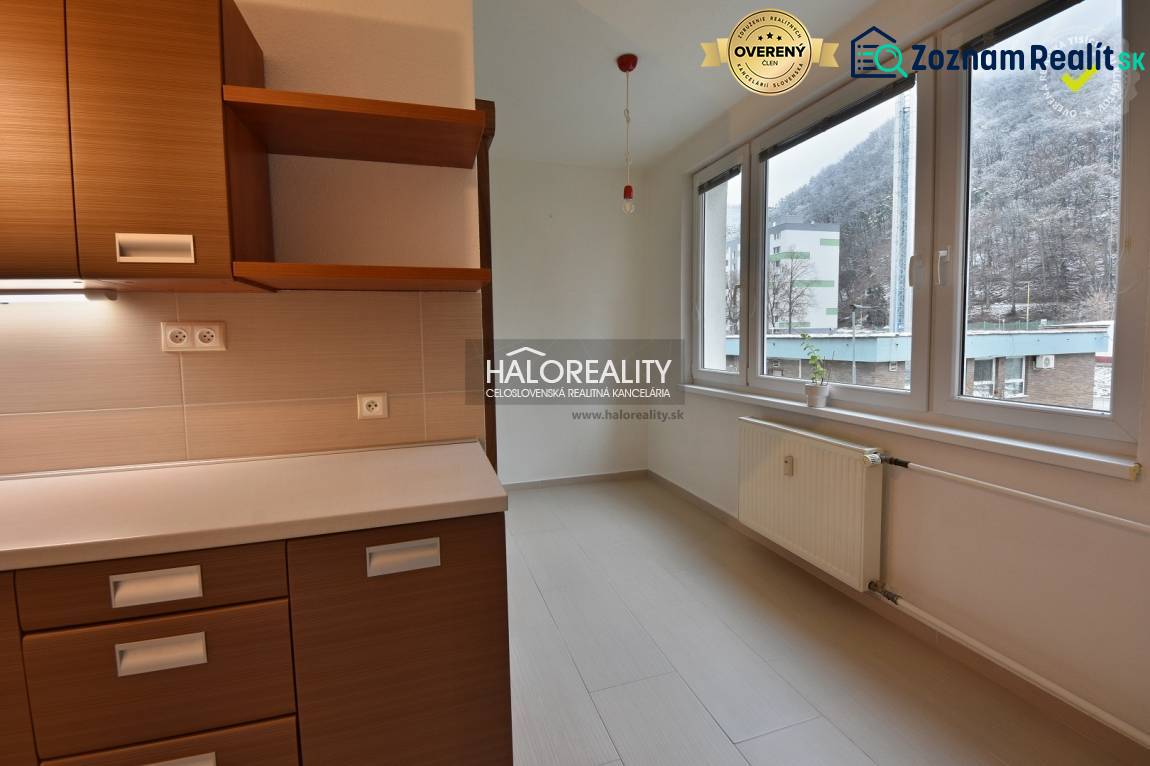 Kitchen unit and windows with a view in a 2-room apartment, floor with wood decor.