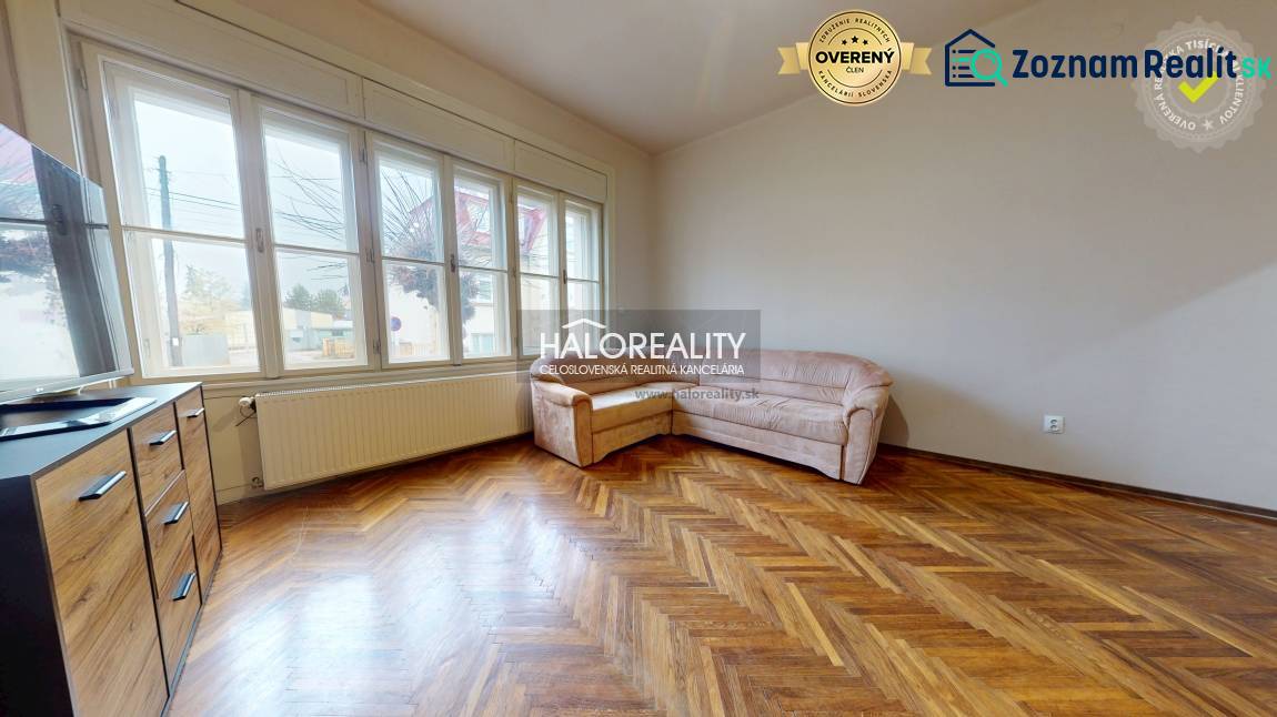 Living room in a 3-room apartment with a wooden decor floor and a sofa.