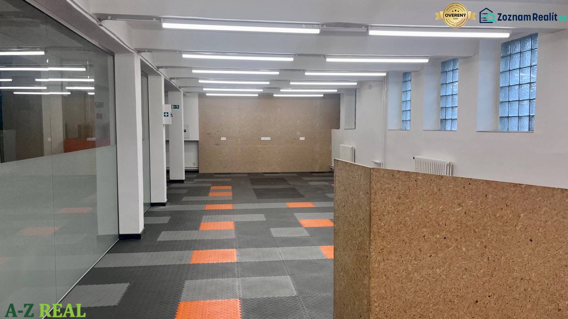 Commercial spaces with divided rooms, gray-orange flooring, and glass walls on Račianska.