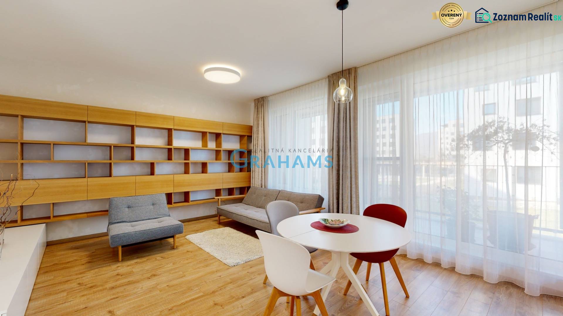 A bright living room with seating, a bookshelf, and a wooden decor floor in a 4-room apartment.