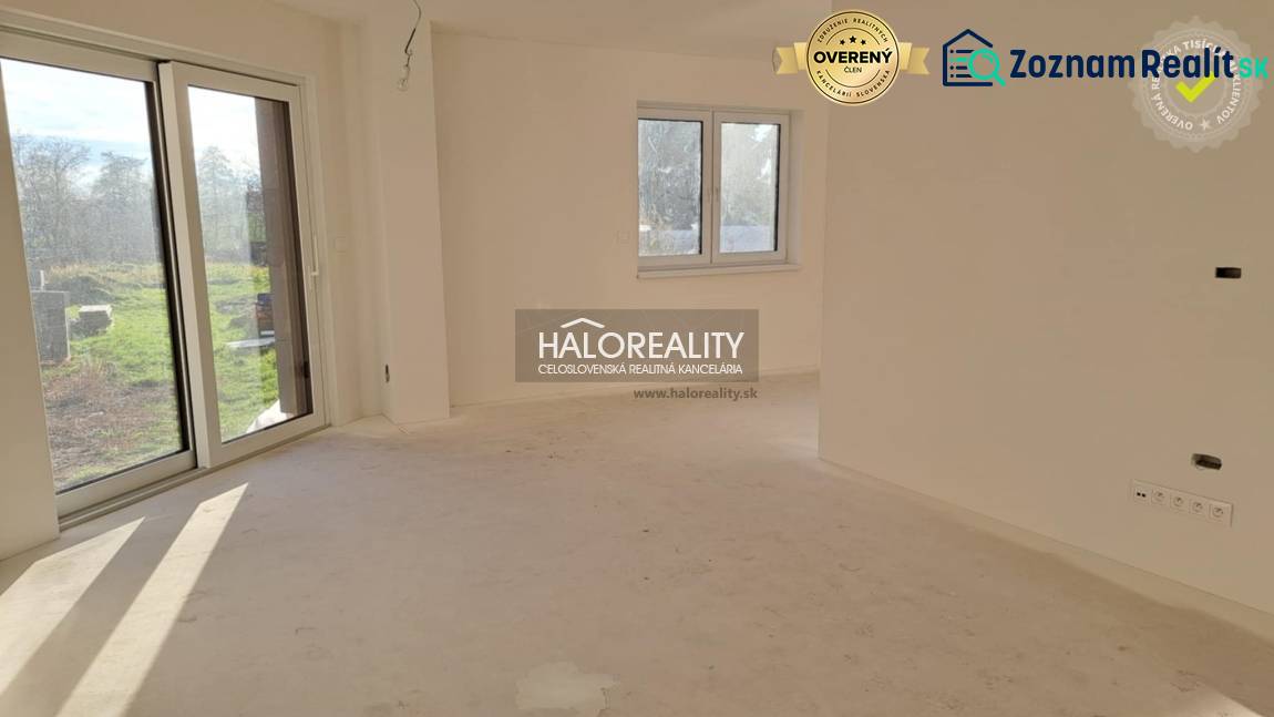 Interior of a family house with a large window, white walls, and patio doors.