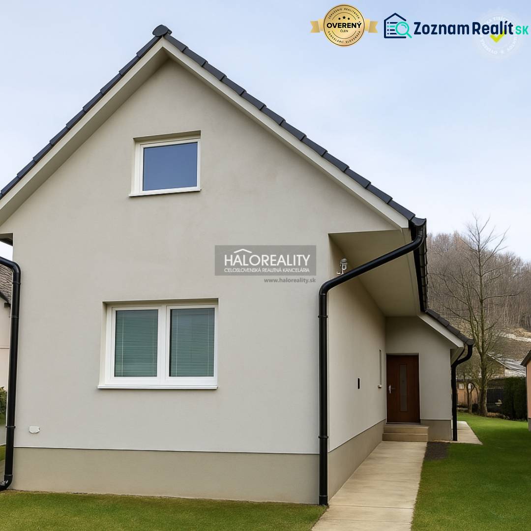 A family house in Kľačno with an attic and grassy surroundings.