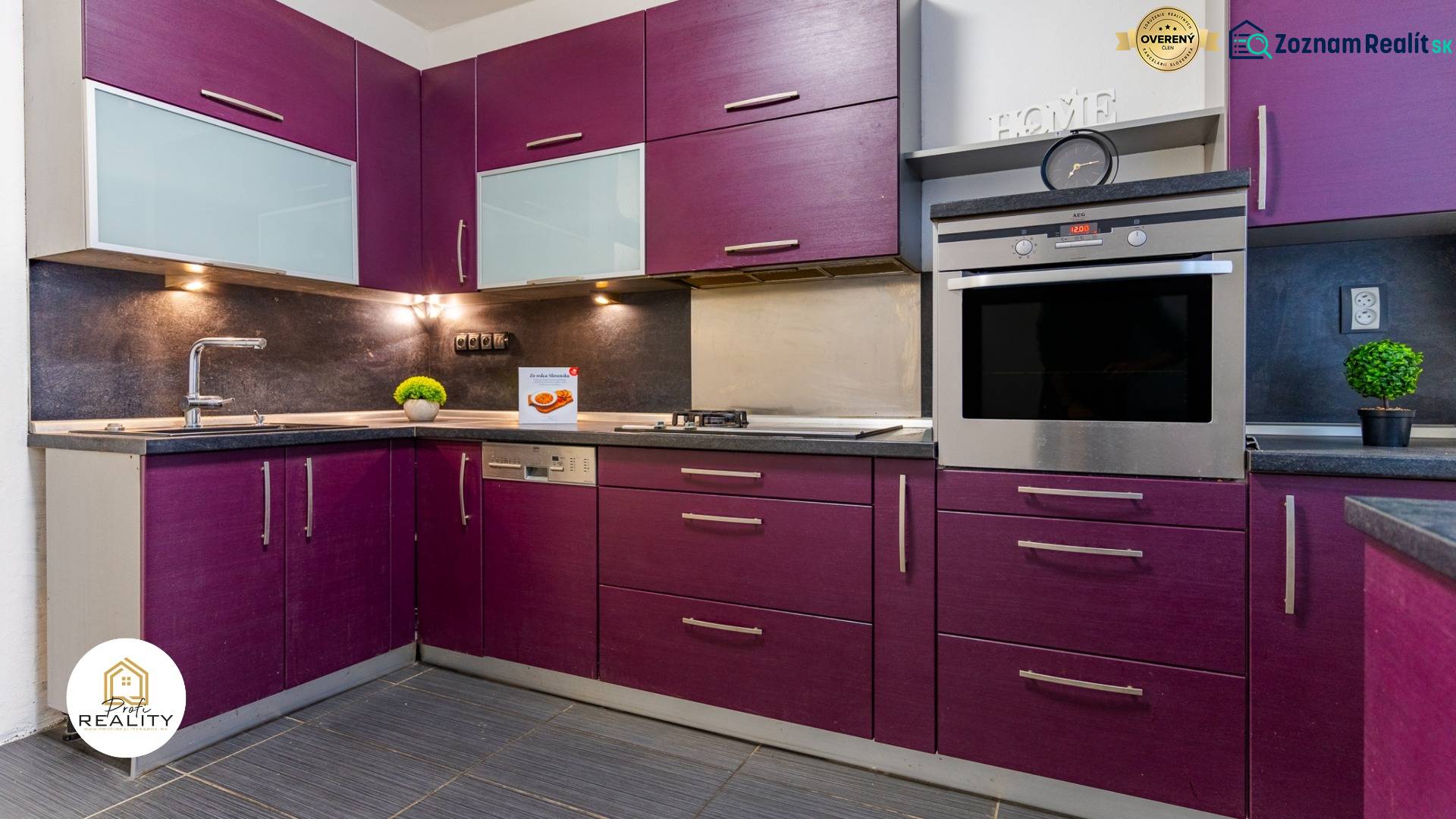 A kitchen with purple cabinets and modern equipment in a 4-room apartment.