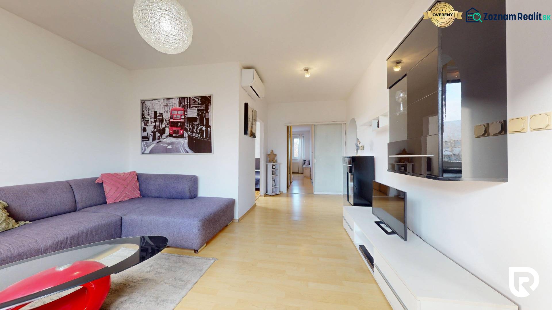 Living room in a 3-room apartment with a sofa, TV unit, and wooden decor flooring.