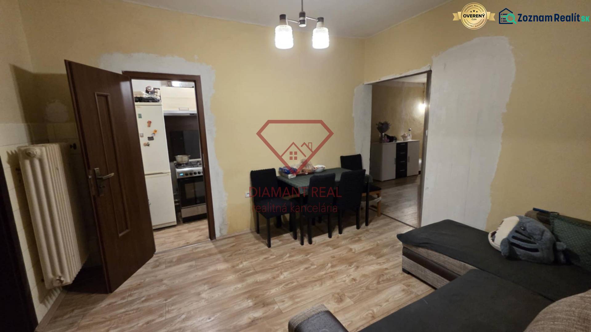 Living room in a family house with a wooden decor floor, table, and sofa.