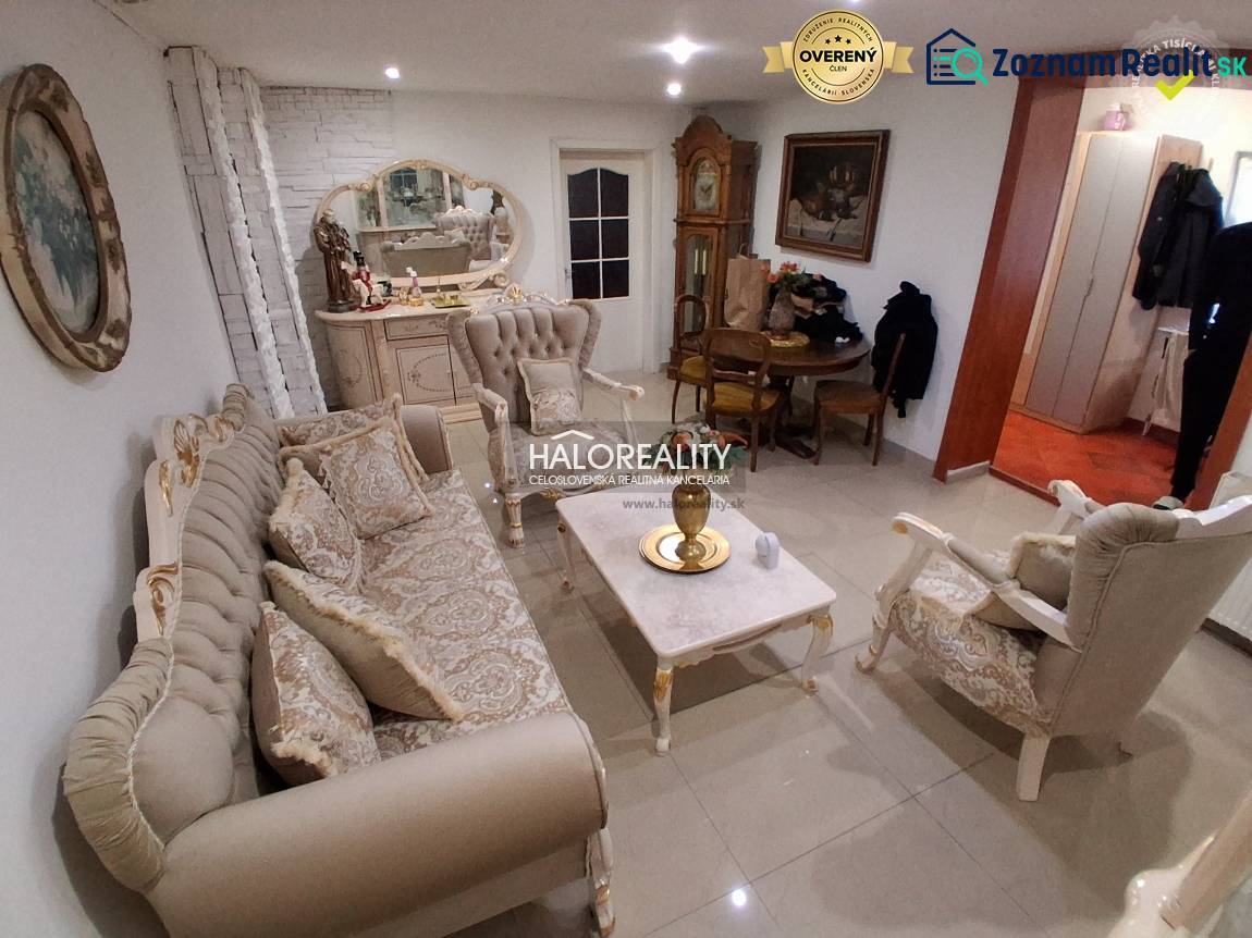 Living room with elegant furniture, a mirror, and a clock in a family house.