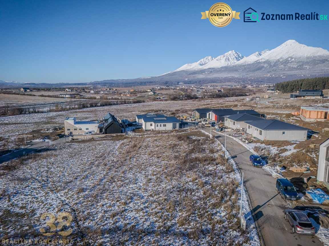 Plots for residential housing in Mlynica with unfinished houses and a snowy landscape.