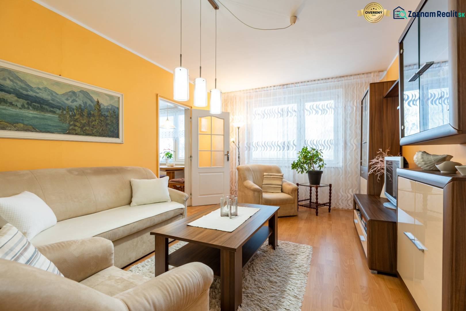 Living room in a 4-room apartment with a wooden decor floor and comfortable seating.