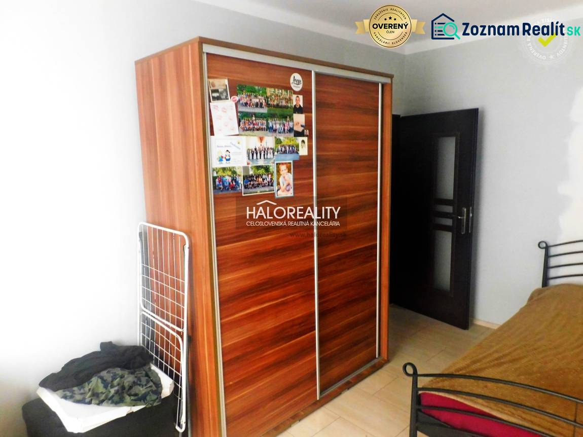 A kitchen with wooden decor and stone cladding in a 2-room apartment.