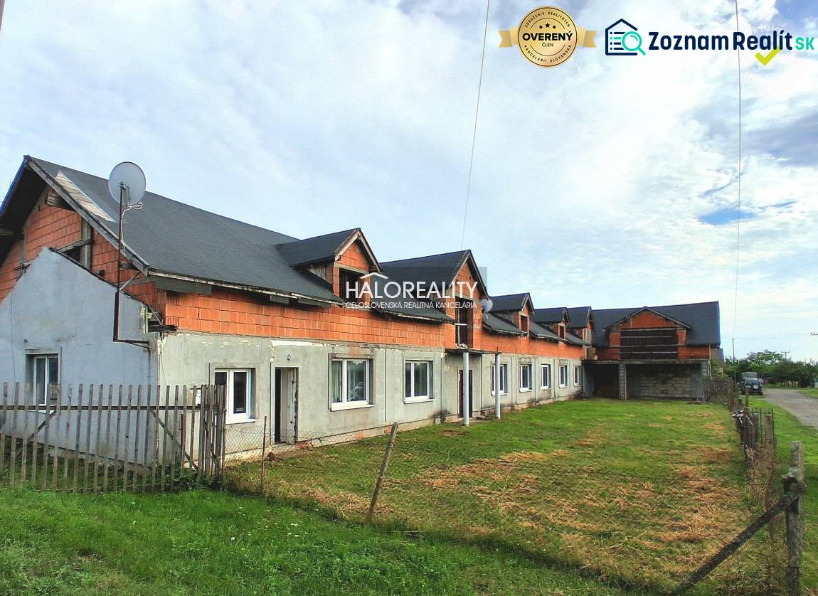 Commercial premises in Tibava, an unfinished building with a grassy area and a fence.