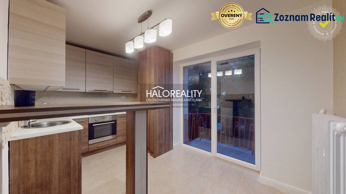 A kitchen in a 2-room apartment with a wooden decor floor and access to a balcony.