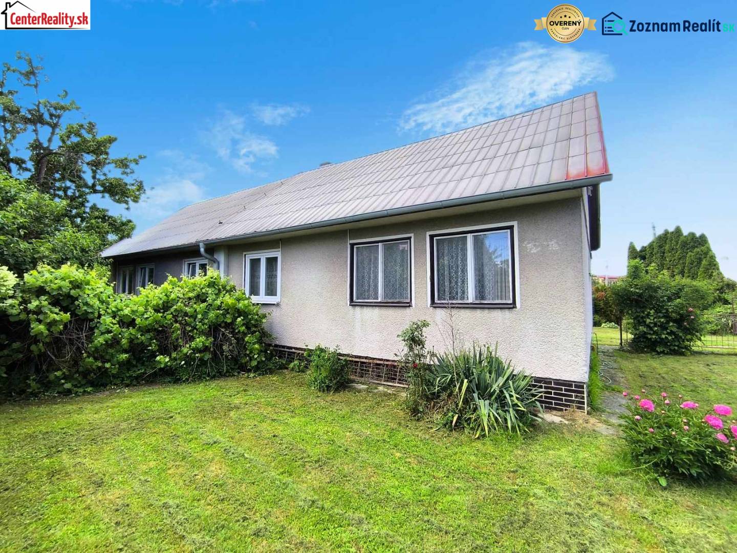 A family house in Nováky with a garden, lawn, and ornamental shrubs.