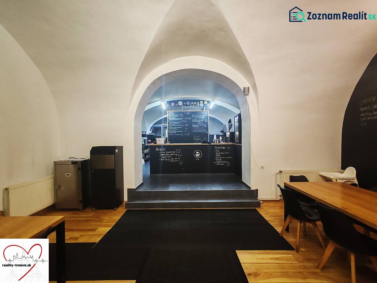 Interior of gastro spaces with vaults, chalkboard walls, and flooring with wood decor.
