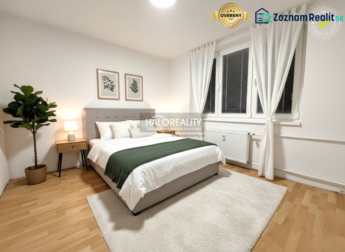 Bright bedroom in a 2-room apartment with wood-patterned flooring, decoration, and a large window.