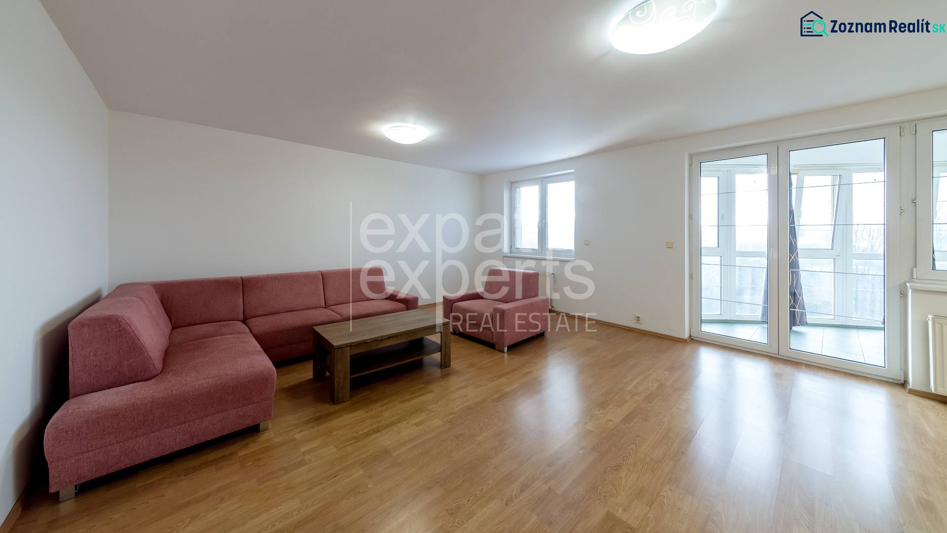 Living room with a sofa set and a wooden decor floor in a 3-room apartment.