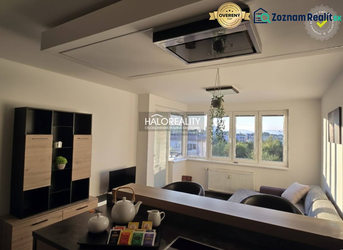 Living room in a two-room apartment with light walls and windows, furnished with furniture.