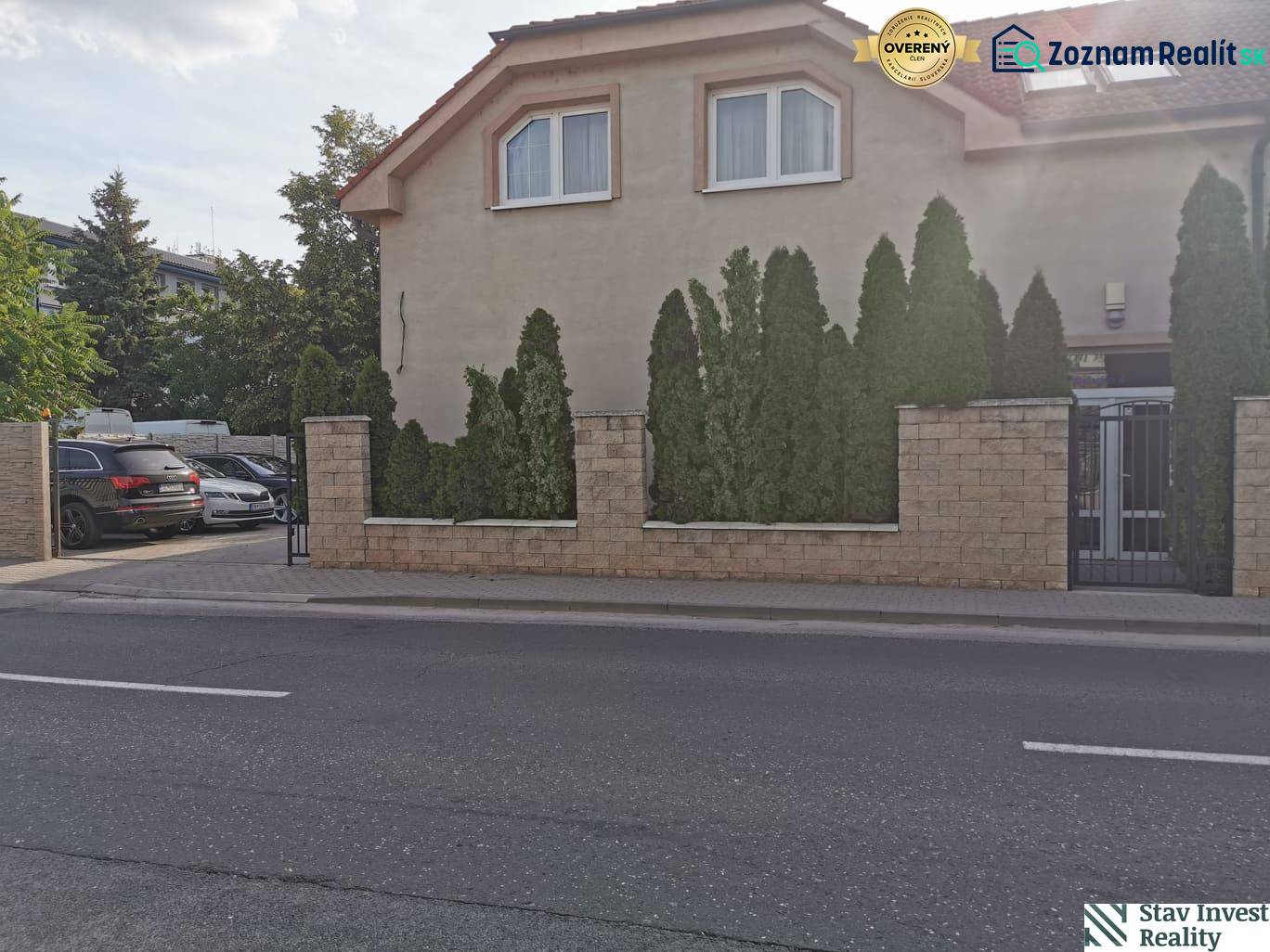 Office building on Šamorínska Street in Senec, with parking and coniferous trees.