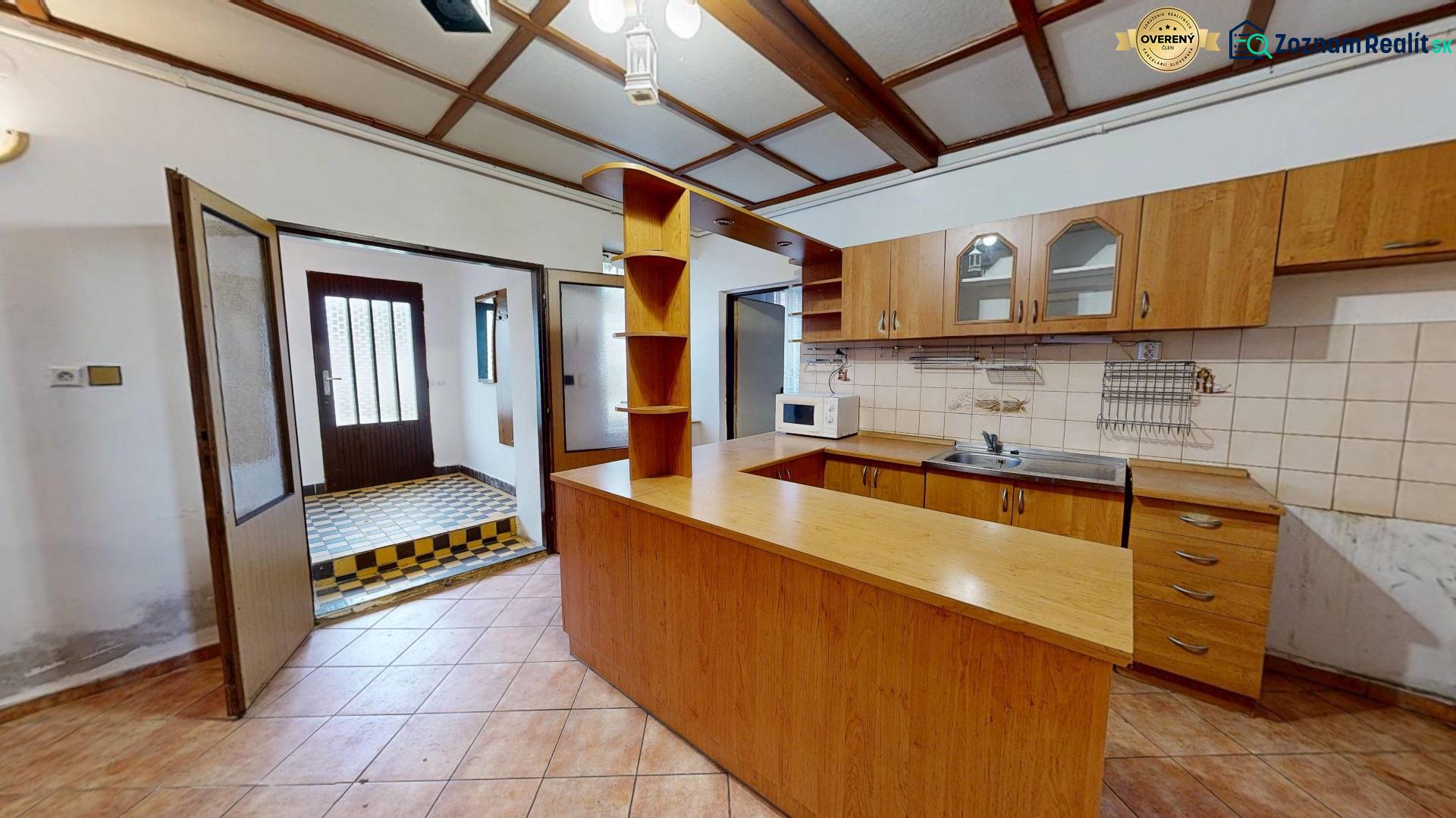 A kitchen with wooden decor and tiles in a family house.