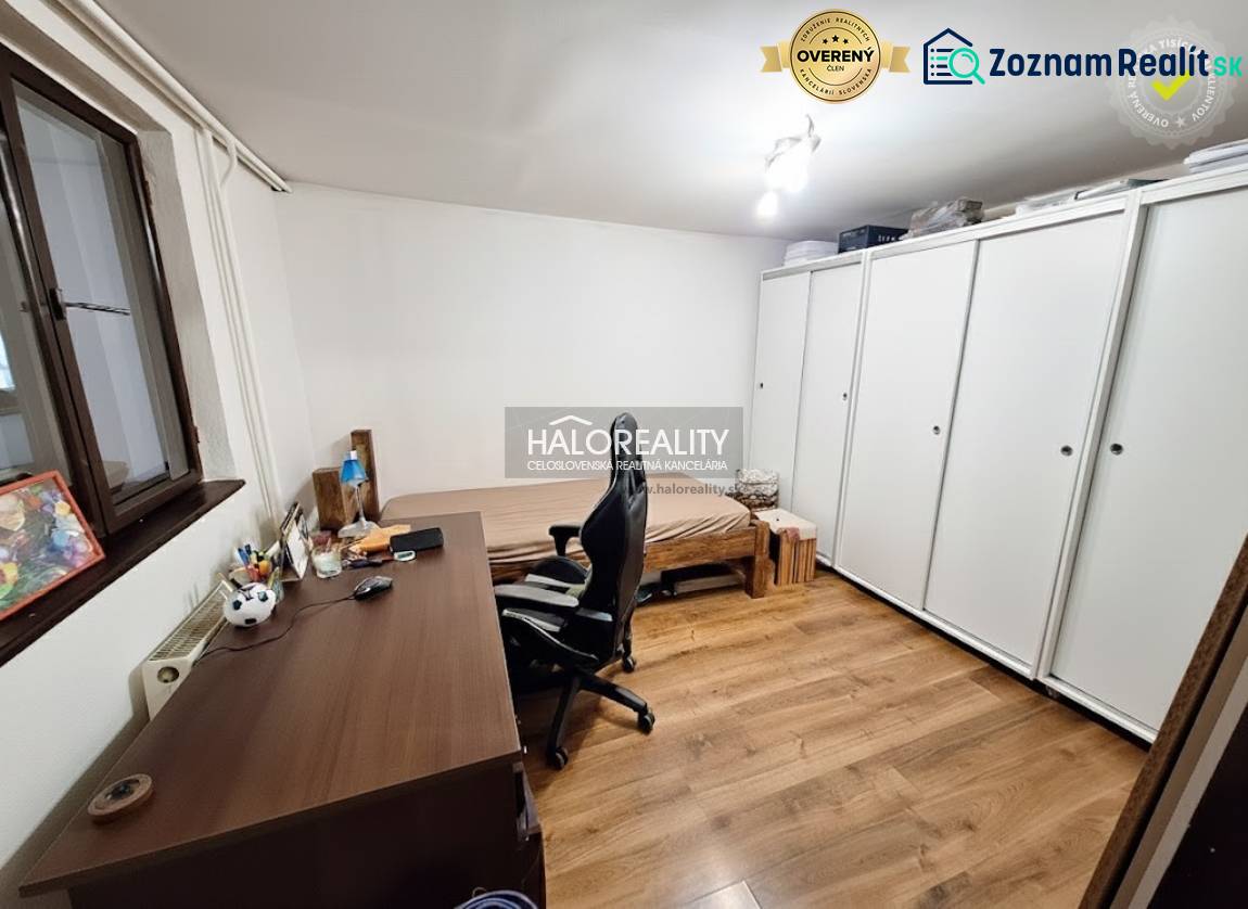 Office with a desk, chair, bed, and wardrobe in a family house.