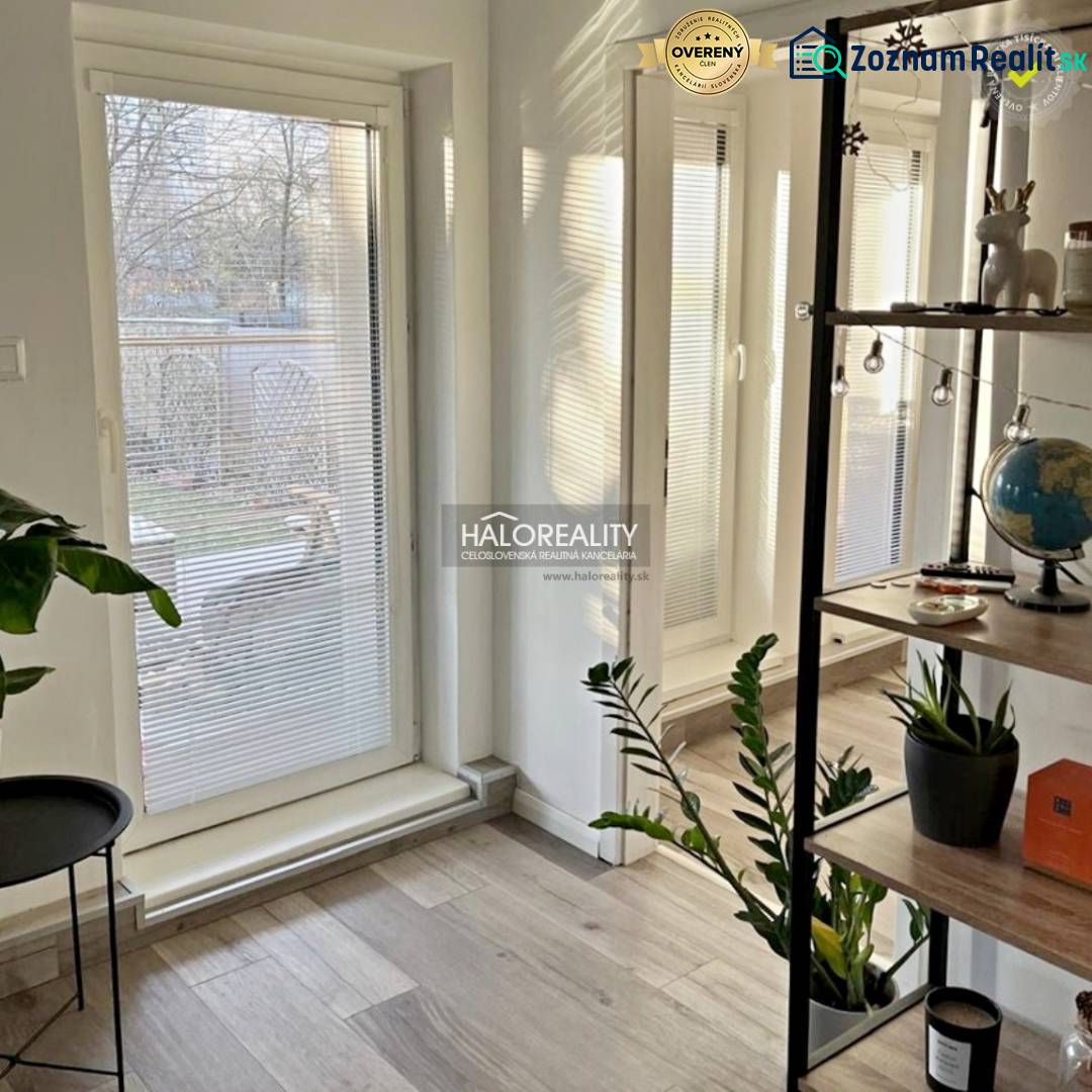 A room with glass doors to the garden and a floor with a wooden decor in a 4-room apartment.
