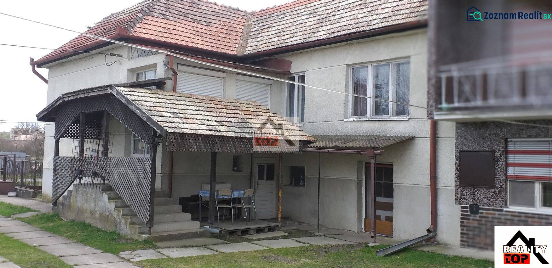 A family house in Studená with a covered terrace and a tiled roof.