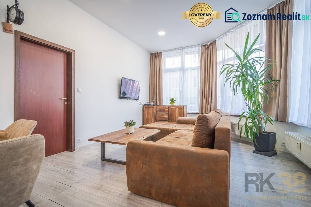 Bright living room, comfortable sofa, large windows, on Hviezdoslavova Street, 4-room apartment.