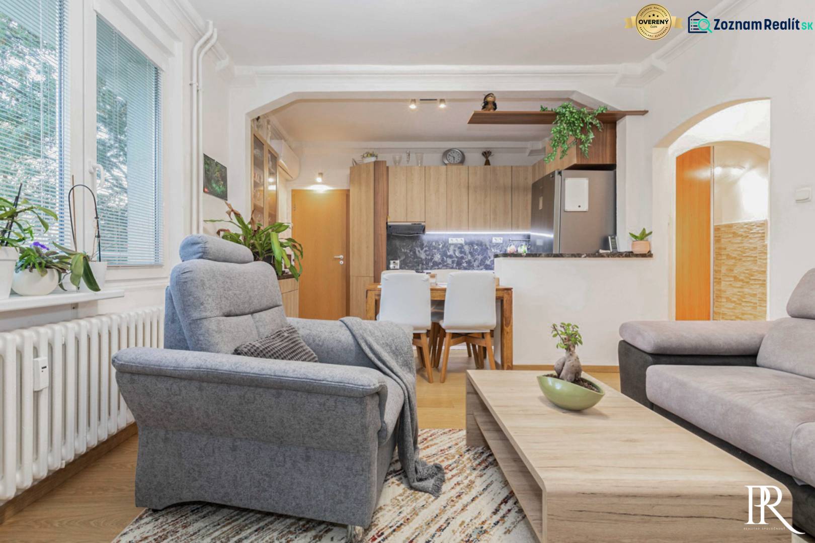 Living room in a two-room apartment with a wooden decor floor and comfortable armchairs.