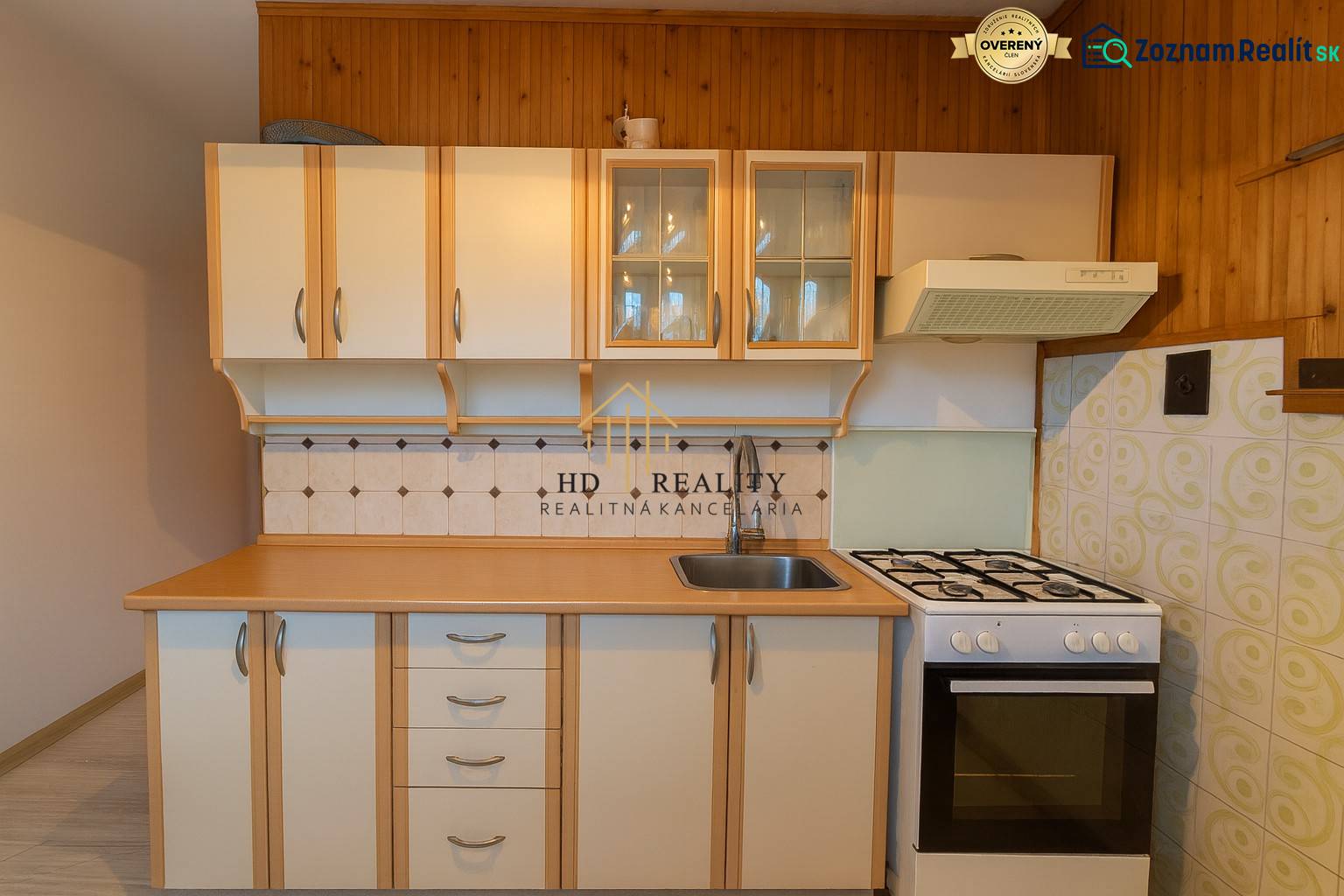 A kitchen in a 3-room apartment with a gas stove and wooden cabinets.