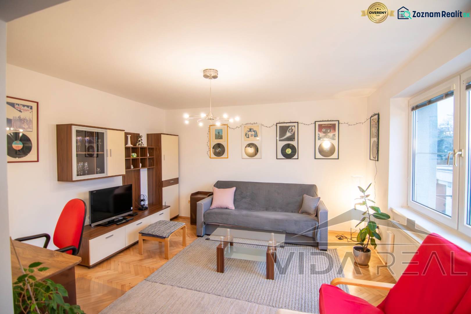 Living room in a two-room apartment with decorations and a wooden decor floor.