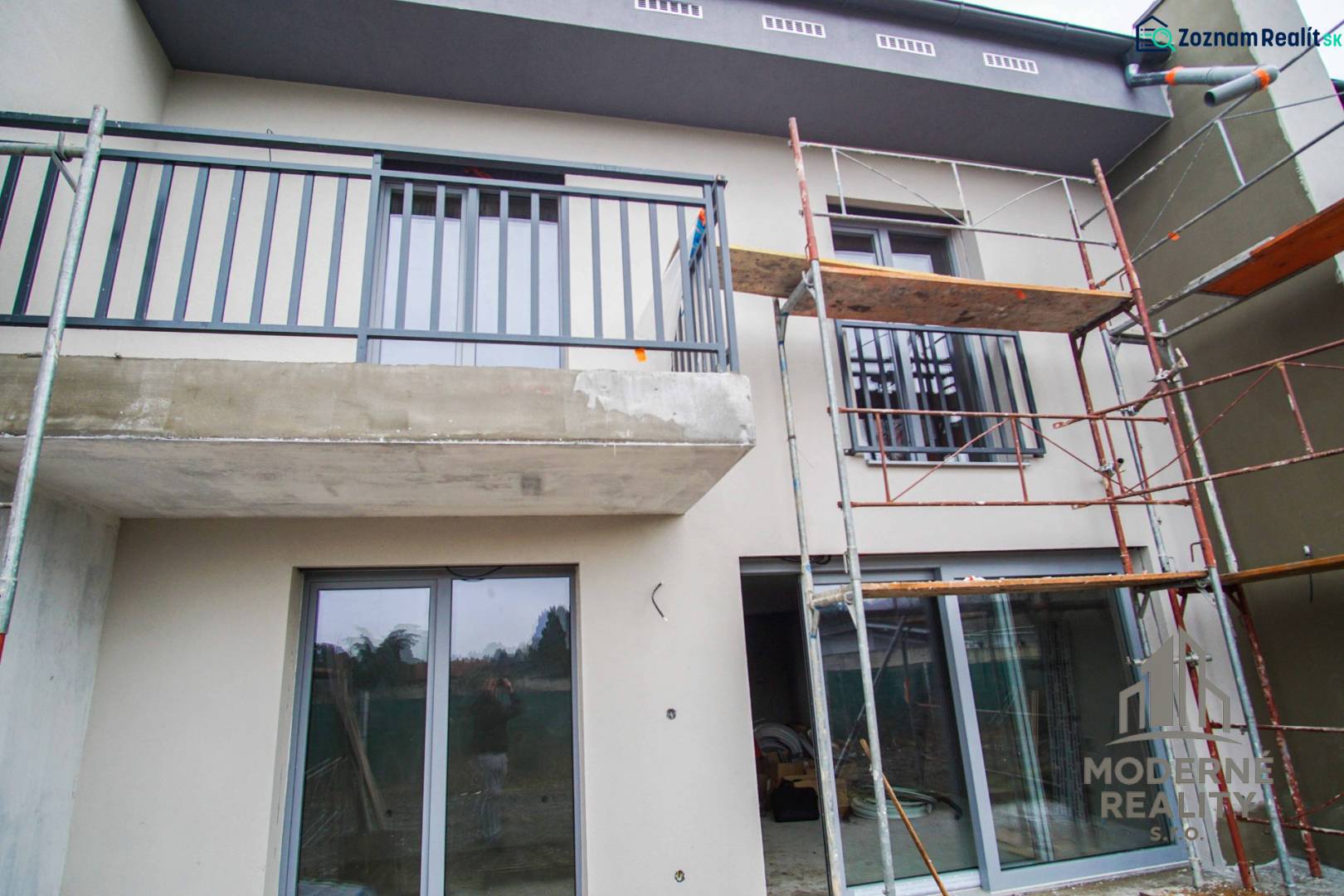 A family house in Nové Zámky is in the reconstruction phase with scaffolding on the facade.