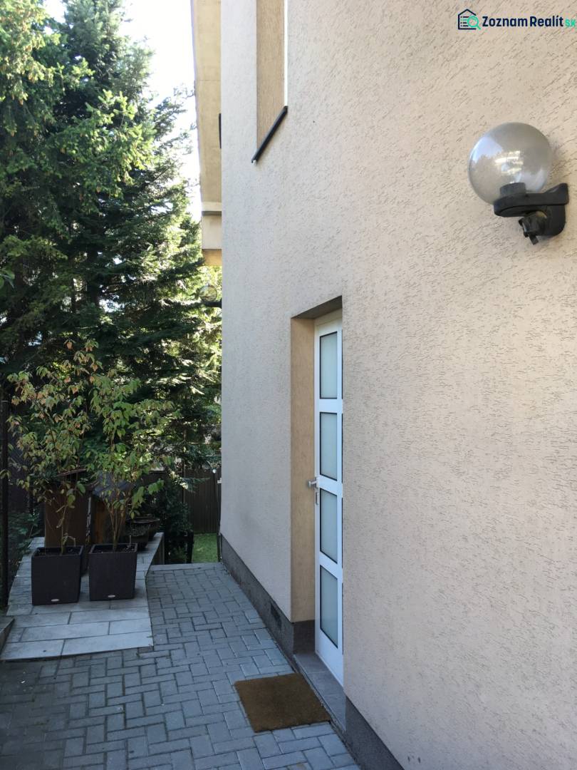 A family house on Mozartova Street in Bratislava - Staré Mesto with a paved walkway and greenery.