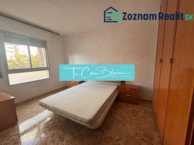 A bedroom in a 4-room apartment with a double bed and a floor with a wood decor.