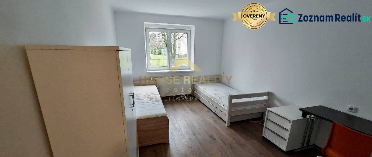 A bright interior in a 2-room apartment with two beds and a floor with a wooden decor.