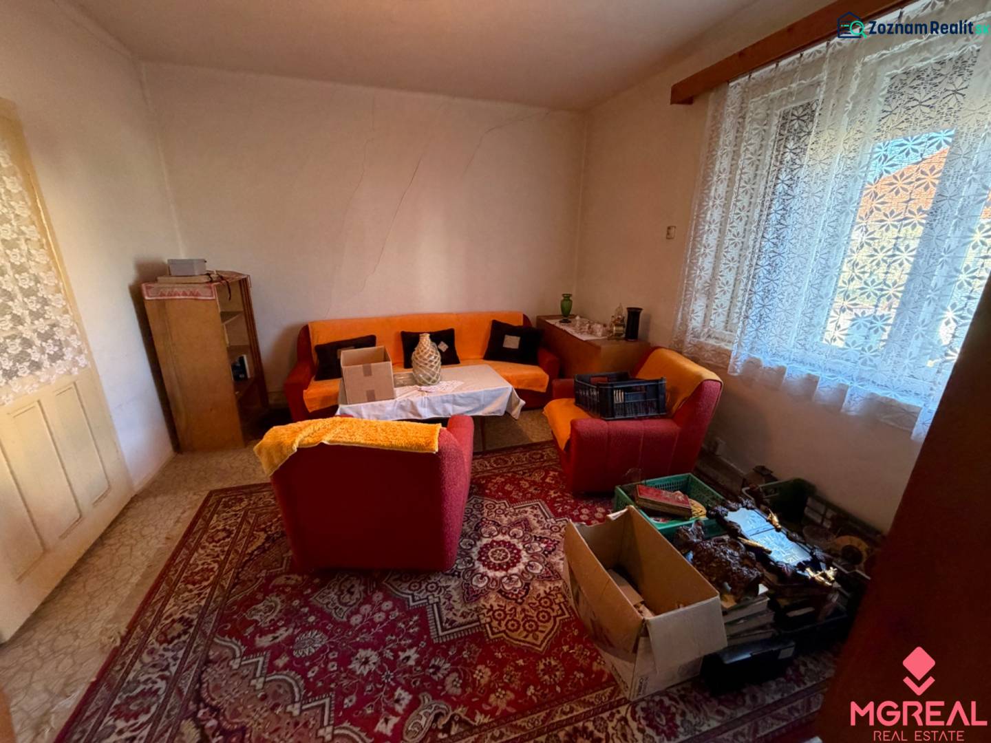 Living room in a family house with carpets and comfortable seating.