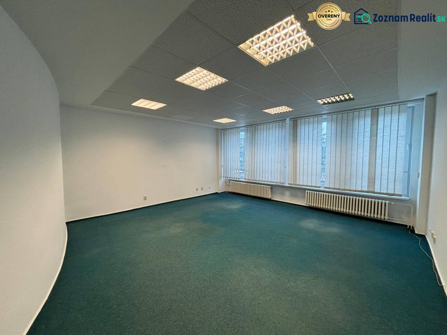 Offices with carpet, fluorescent lighting, and vertical blinds.