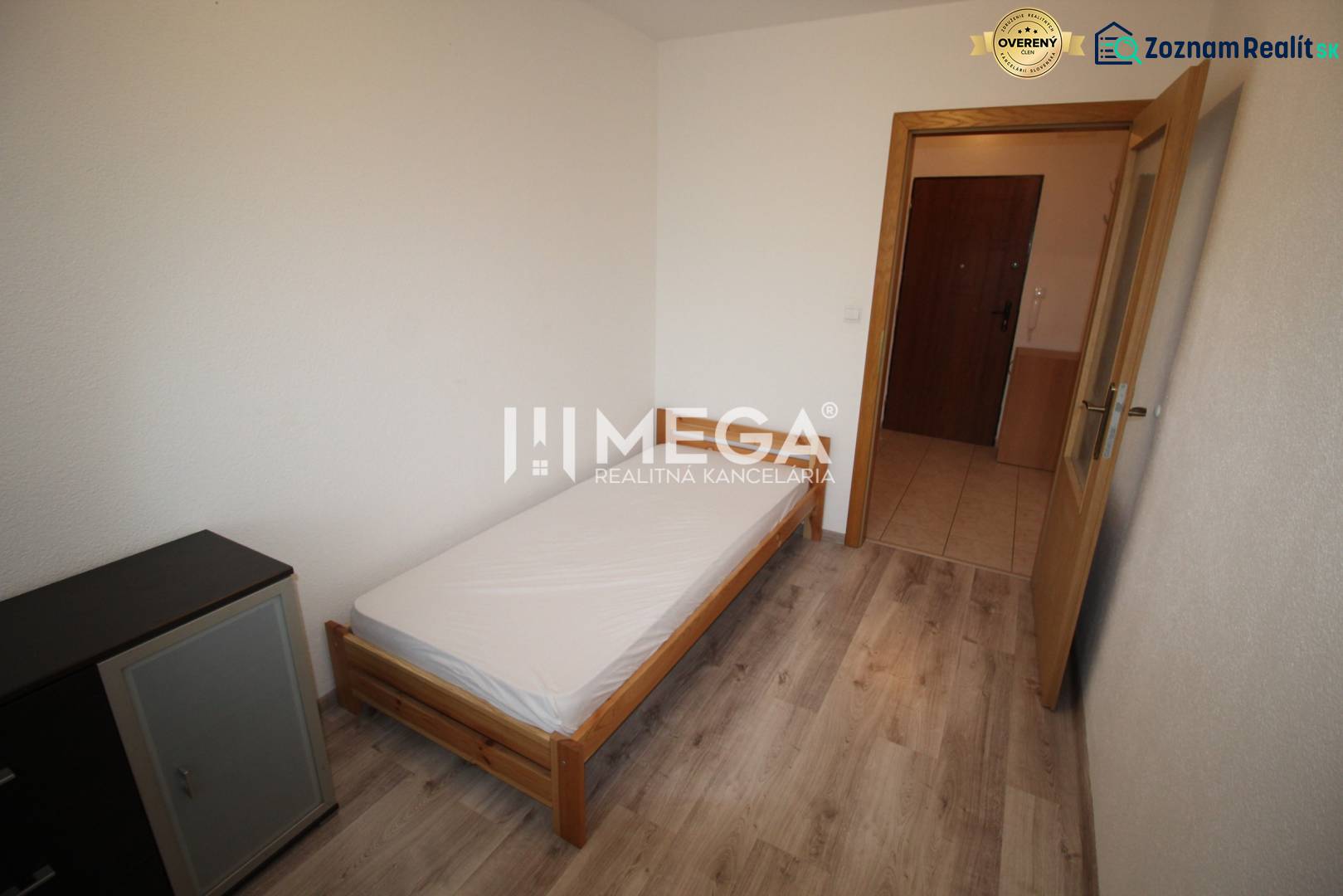 A bedroom with a bed, a dresser, and a floor with a wooden decor in a two-room apartment.