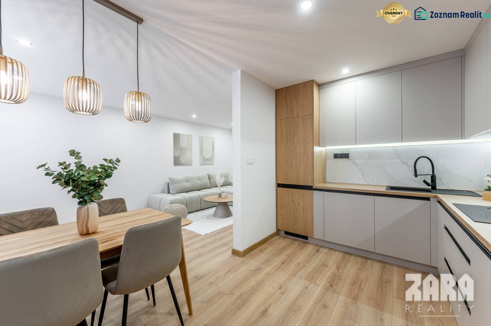 A kitchen with a wooden decor, integrated into the living area in a 3-room apartment.