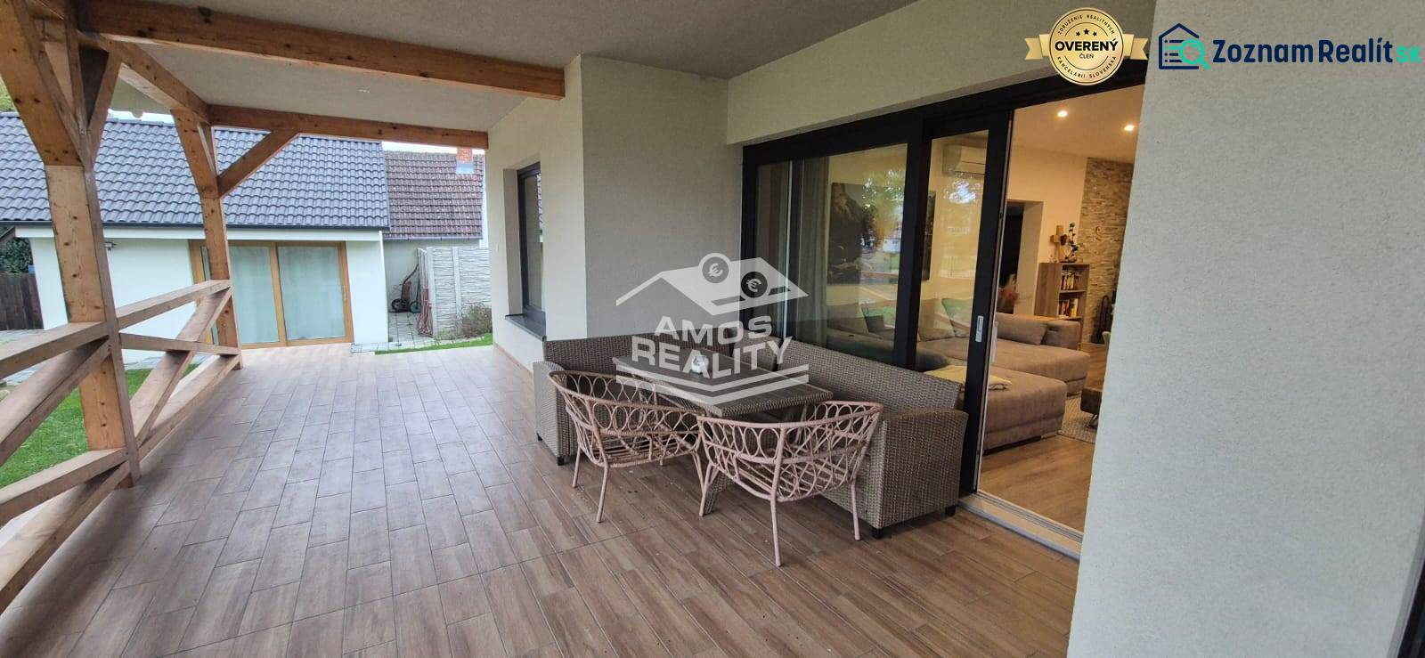 Terrace of a family house in Studienka with glass doors and a wooden decor floor.