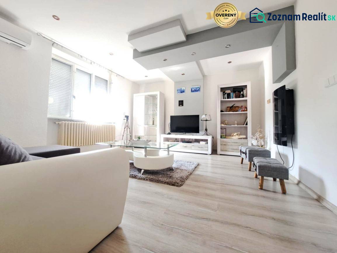 Living room in a family house with a wooden decor floor and a sofa.