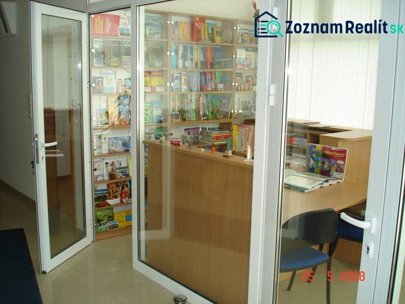 Glazed commercial spaces with books and brochures behind a wooden counter.