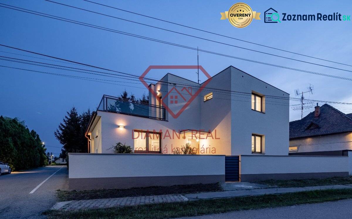 A family house on Trnovecká Street in Trnovec nad Váhom illuminated at dusk.